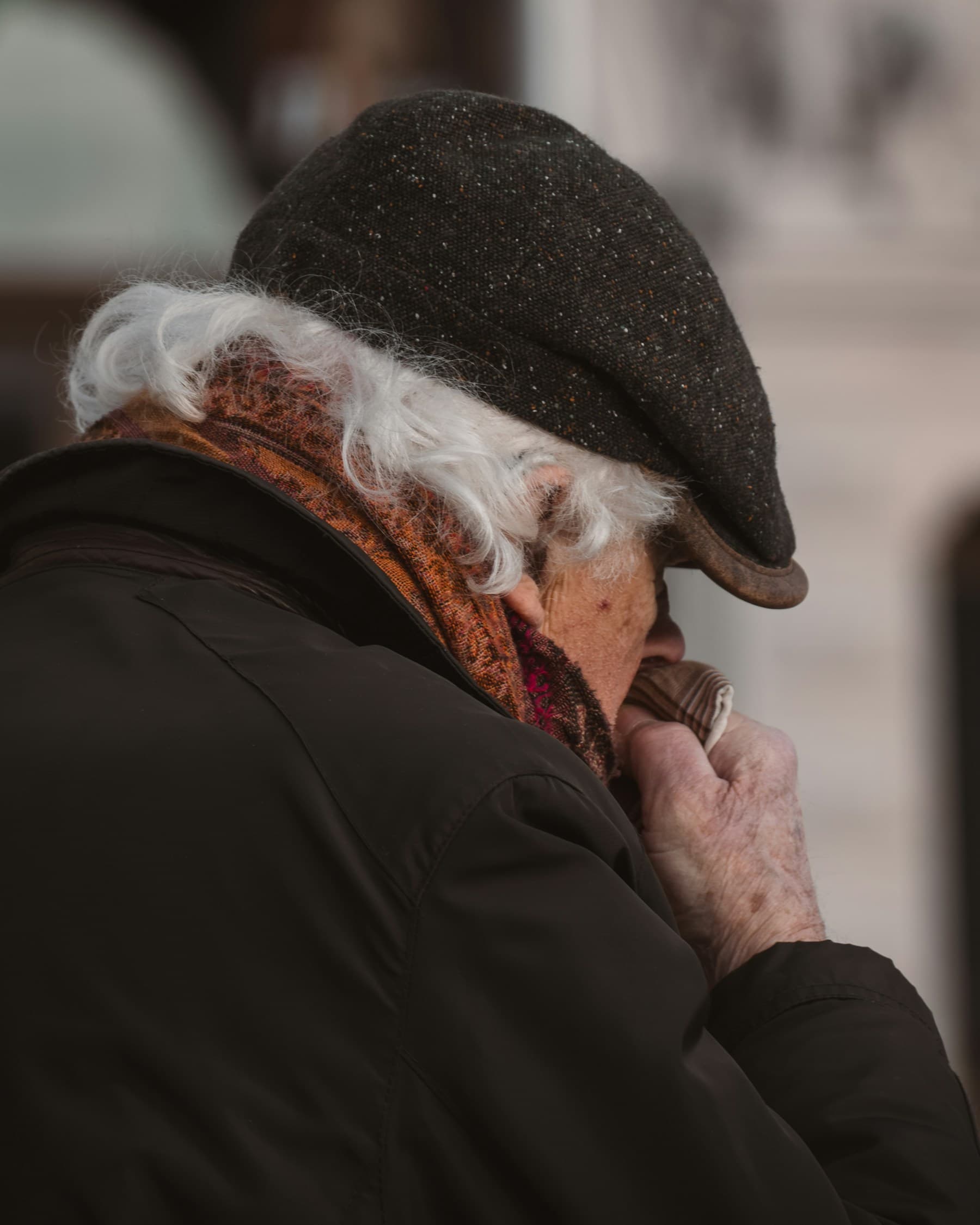 An older man concentrating on a phone call at home