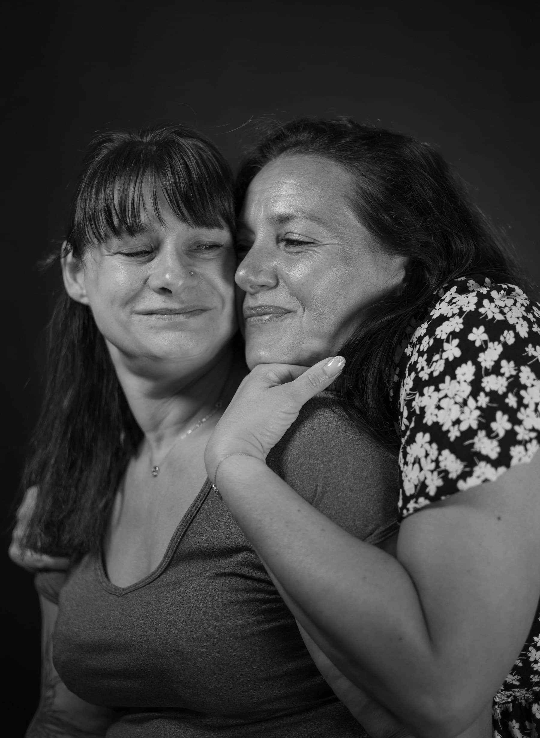 An adult daughter and her older mother sharing a tender moment together