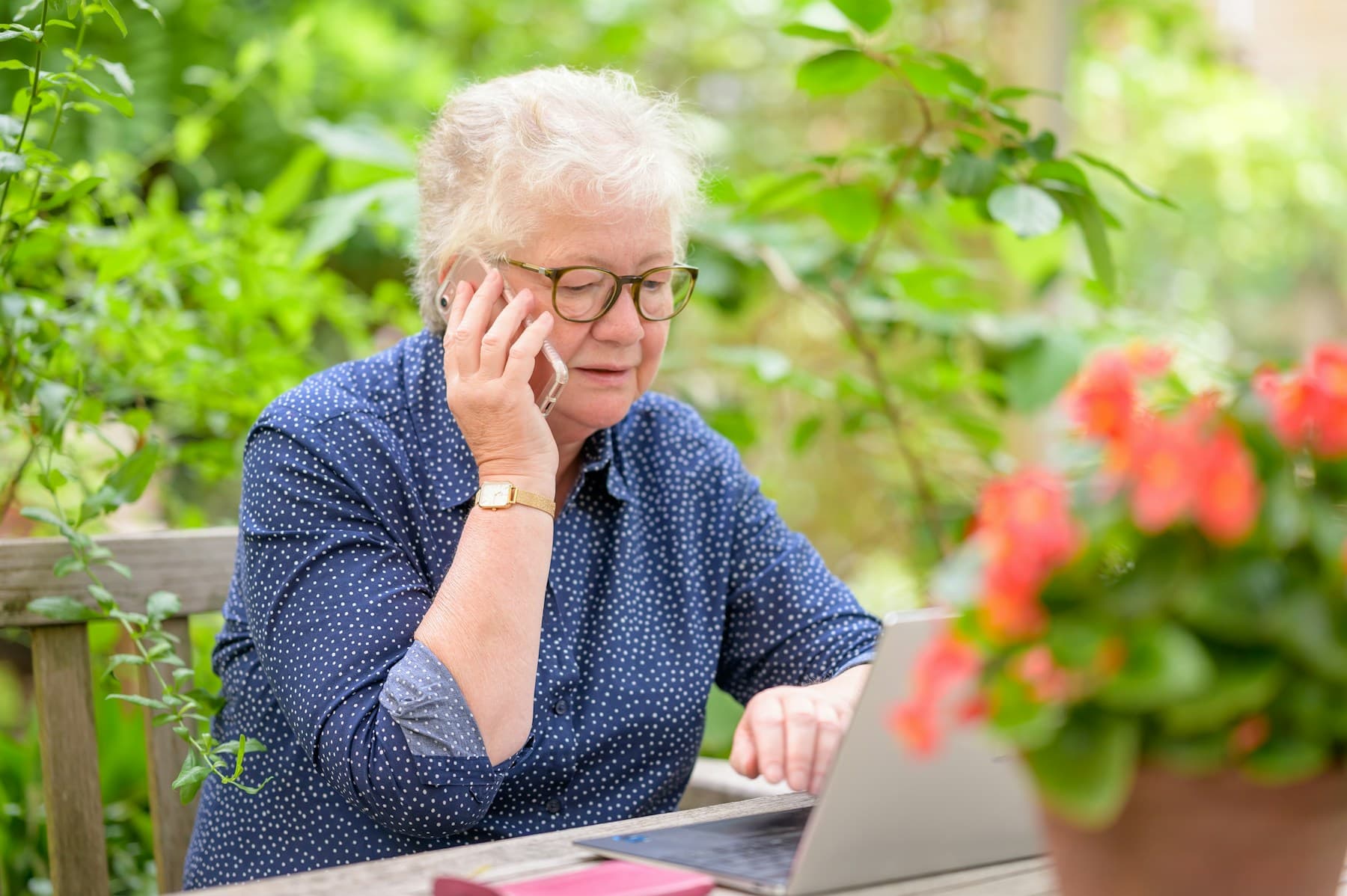 An older woman using a laptop at home