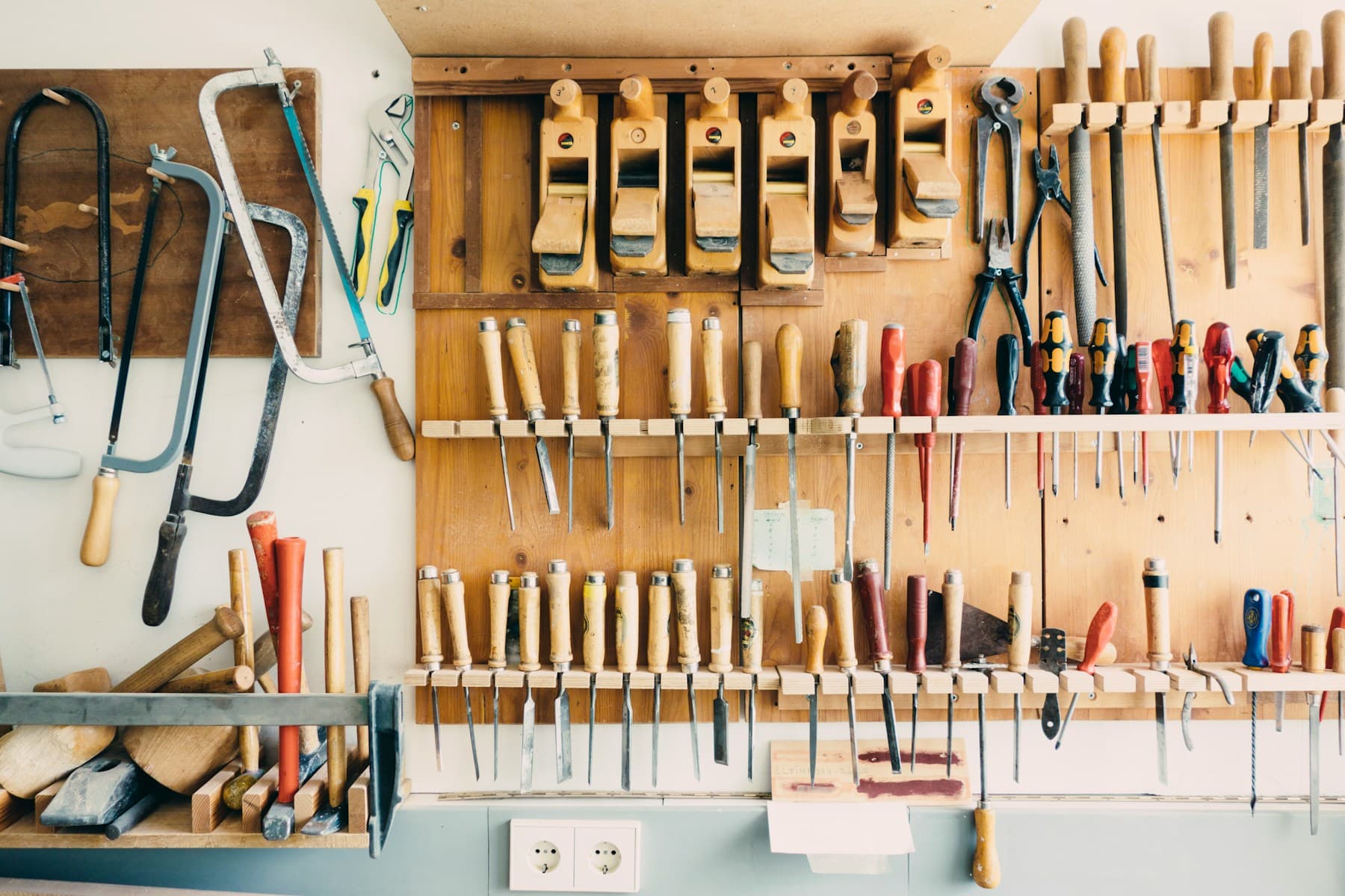 Hand tools arranged on a rack in a workshop